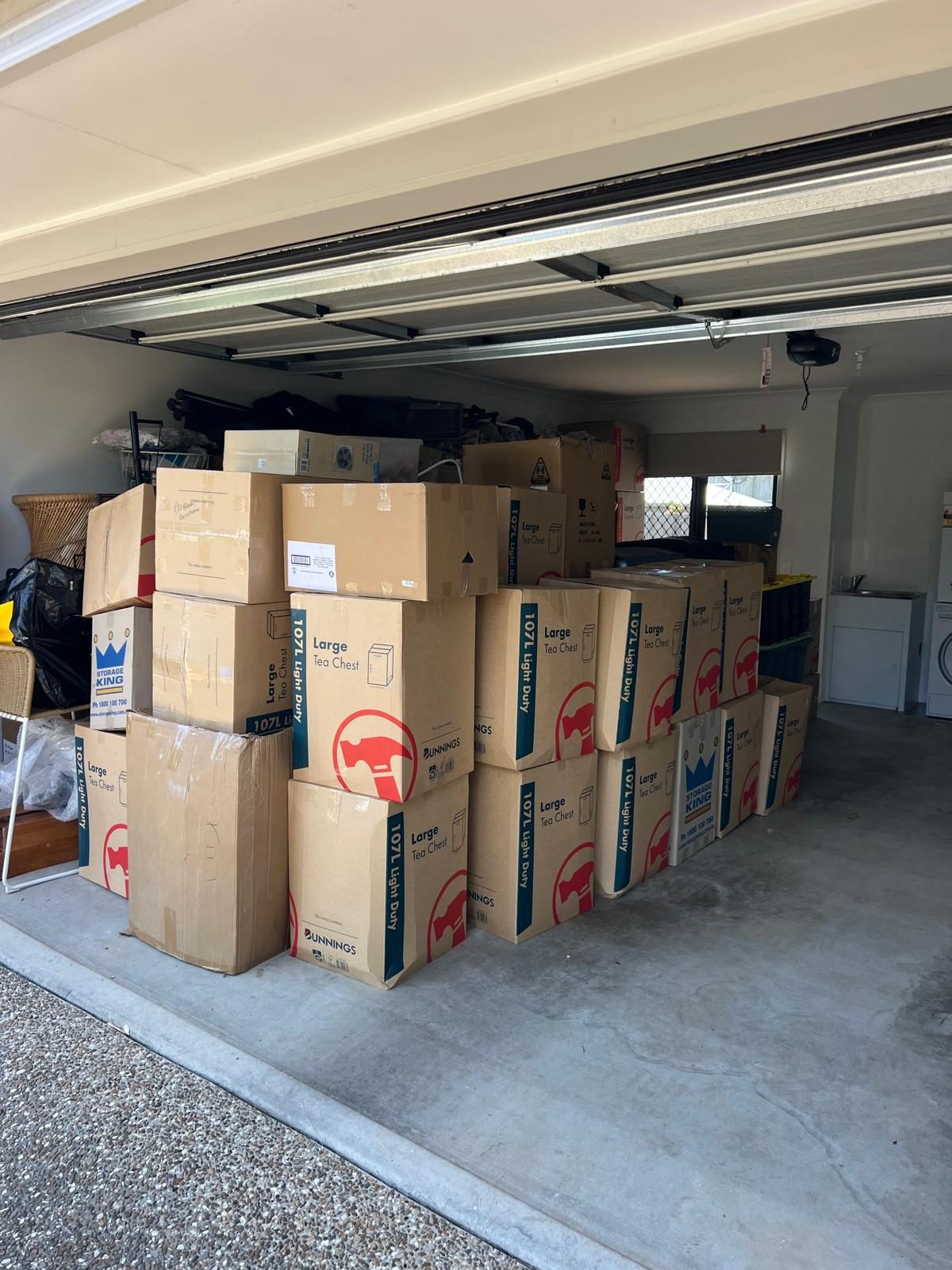 Boxes and furniture delivered and stacked in a garage