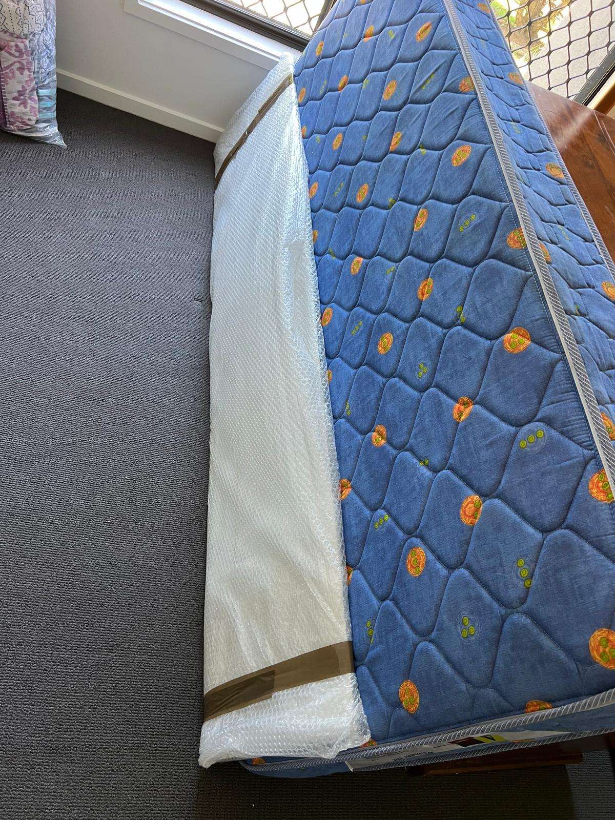 Mattress in a protective cover ready to move