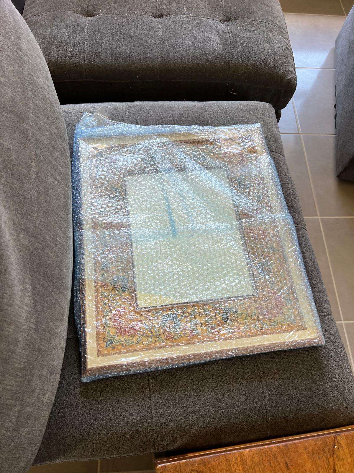 Framed picture wrapped in plastic for the move